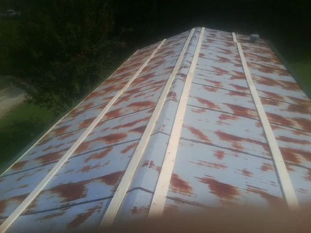 Rusted metal roof panels with new wood purlins before replacement — Storm Damage Roof Repair in Hobart by Roofing Brothers