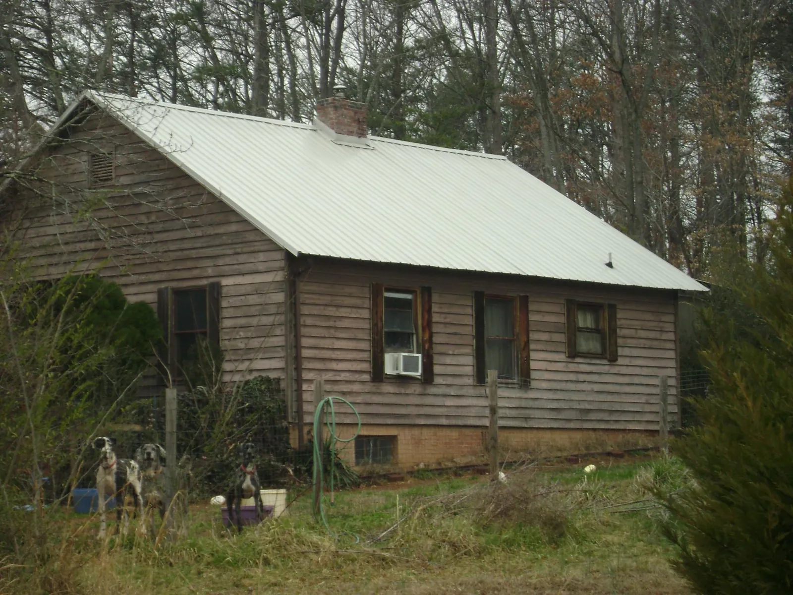 White metal roof on an old wood sided farmhouse, from a Metal Roof Installation job in Hobart